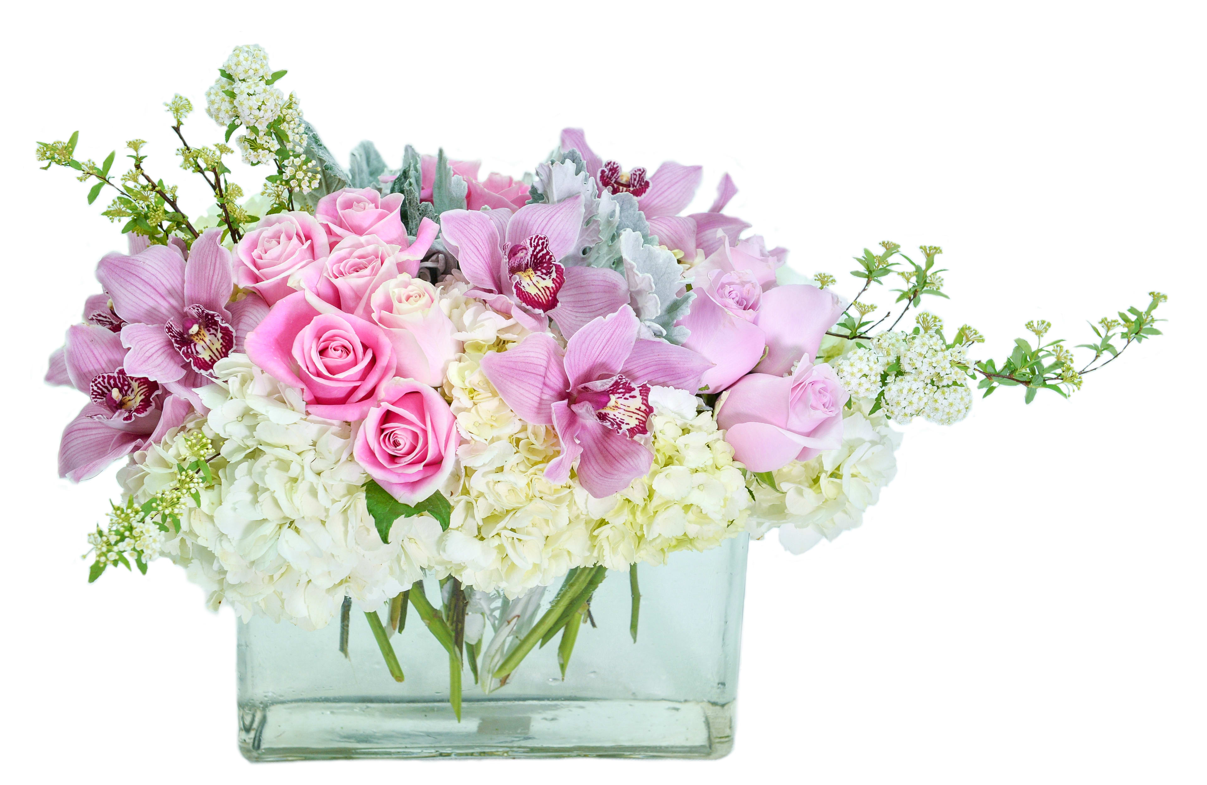 Pink roses and orchids in a clear rectangular vase