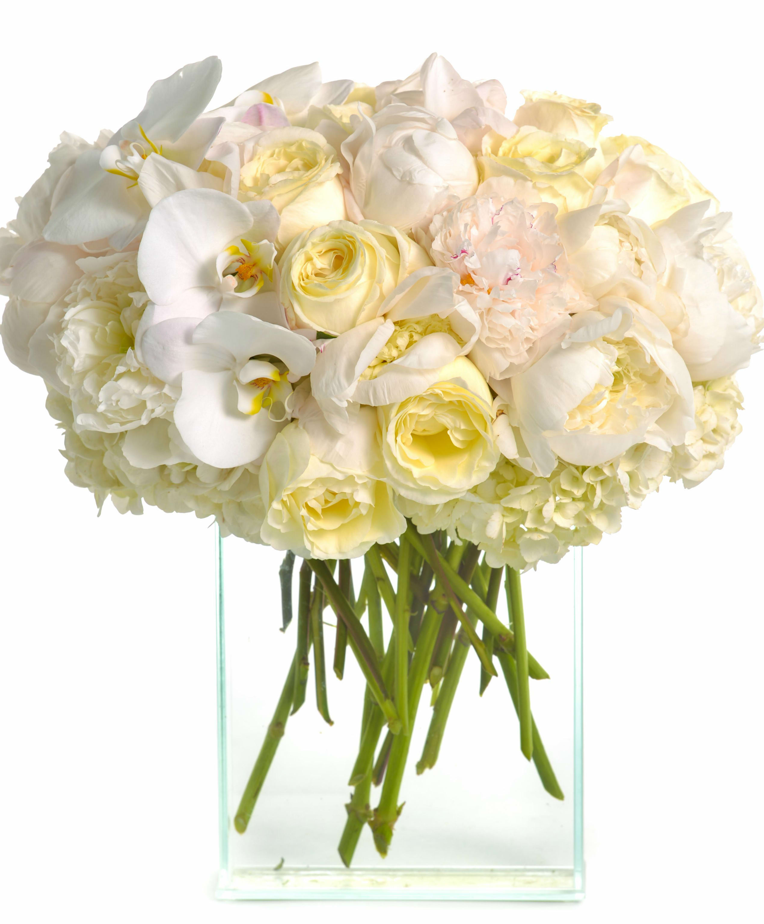 White and pale yellow bouquet in a clear glass vase