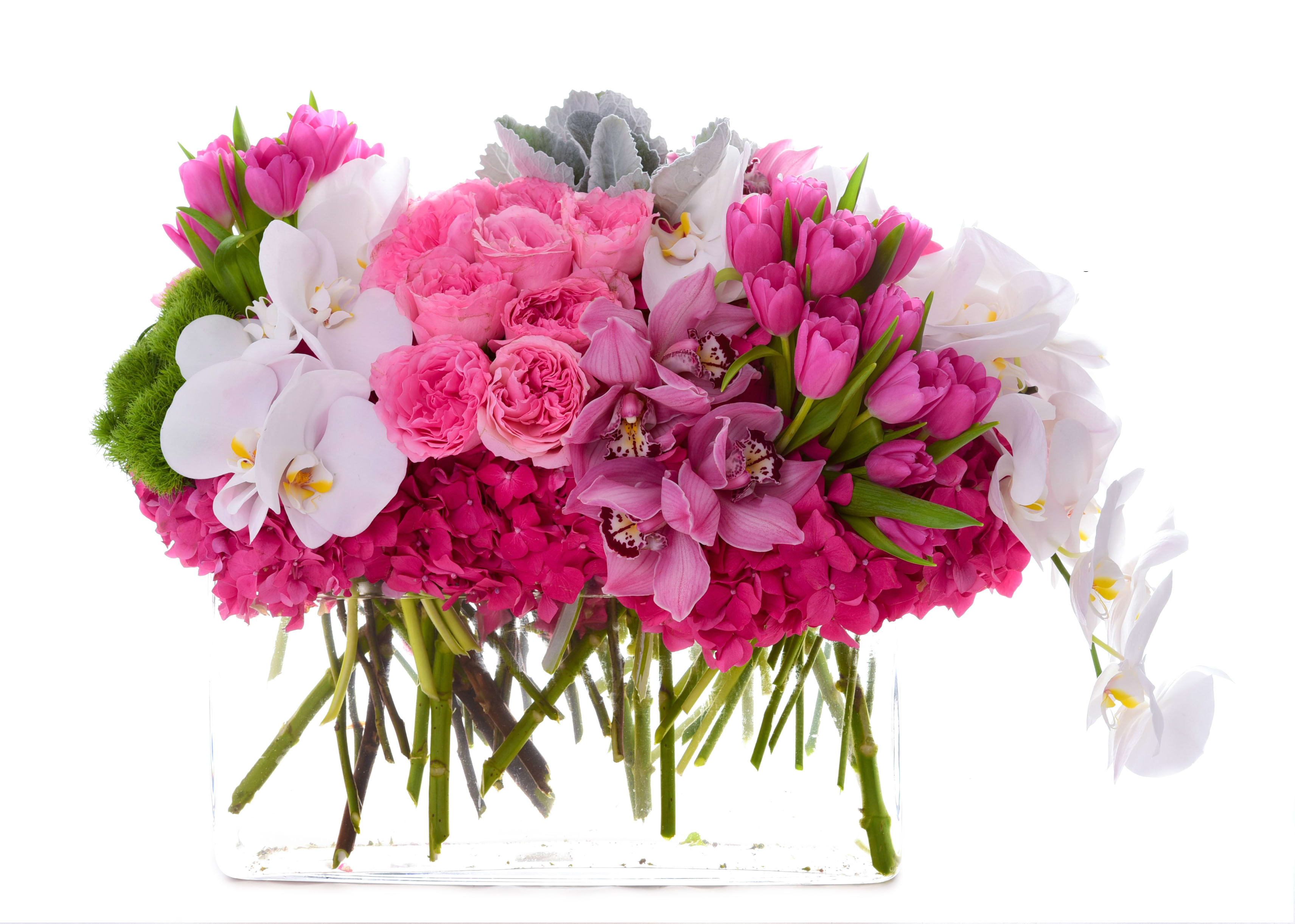 Pink and white floral arrangement in a clear rectangular vase