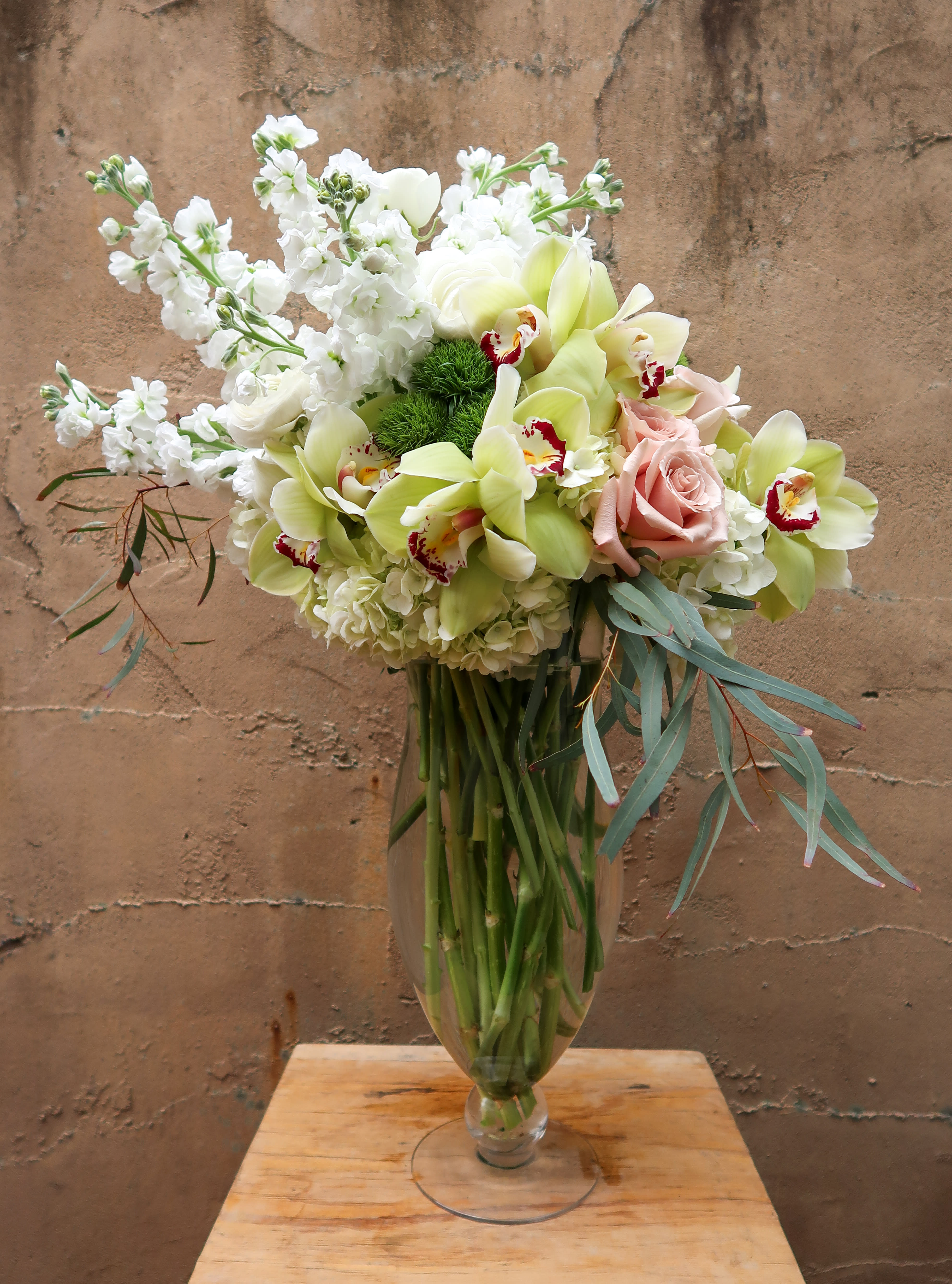 Champagne  - Mother’s Day 2021 Exclusive Collection. Champagne is a tall glamours arrangement featuring the seasons blooms. 