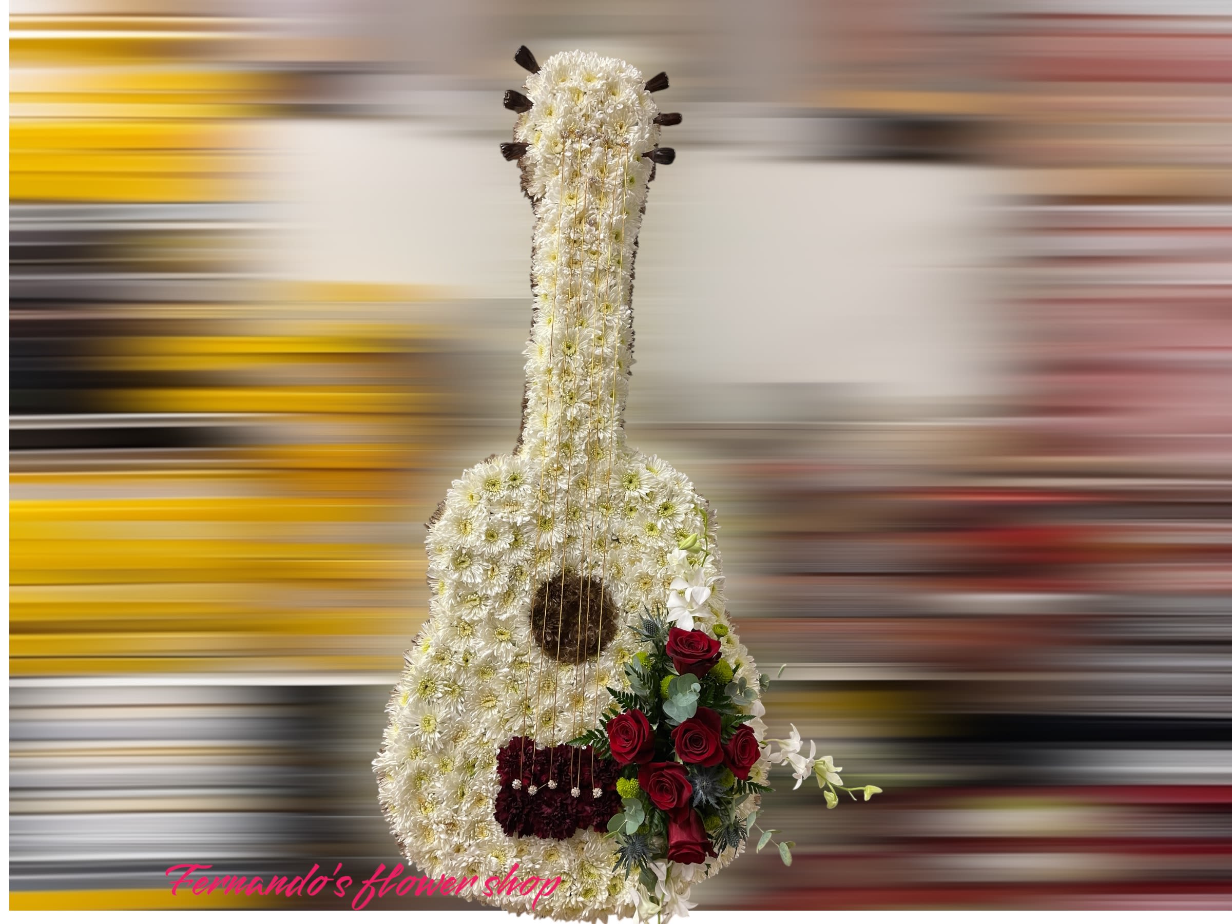 Tall guitar-shaped floral tribute in white with red roses and gold string accents
