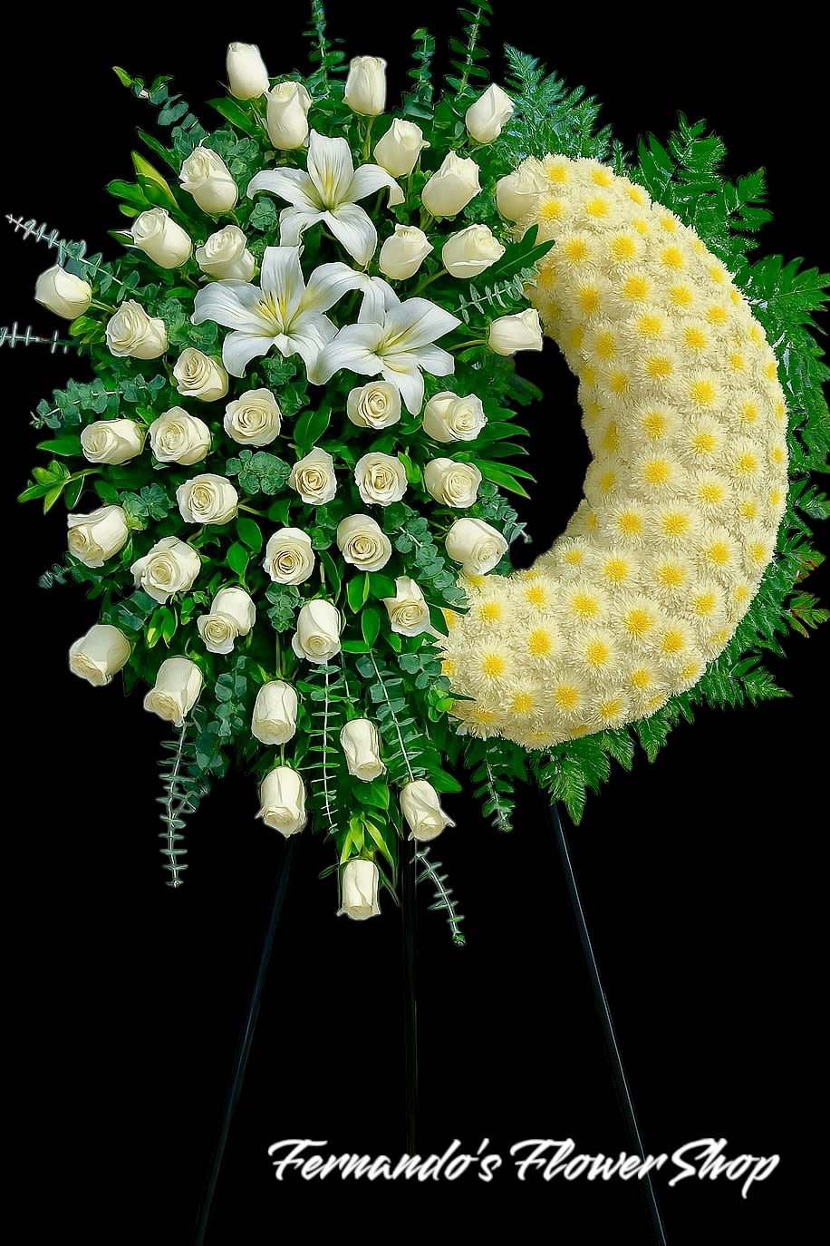 Standing crescent spray of white roses, lilies, and pale yellow chrysanthemums on an easel