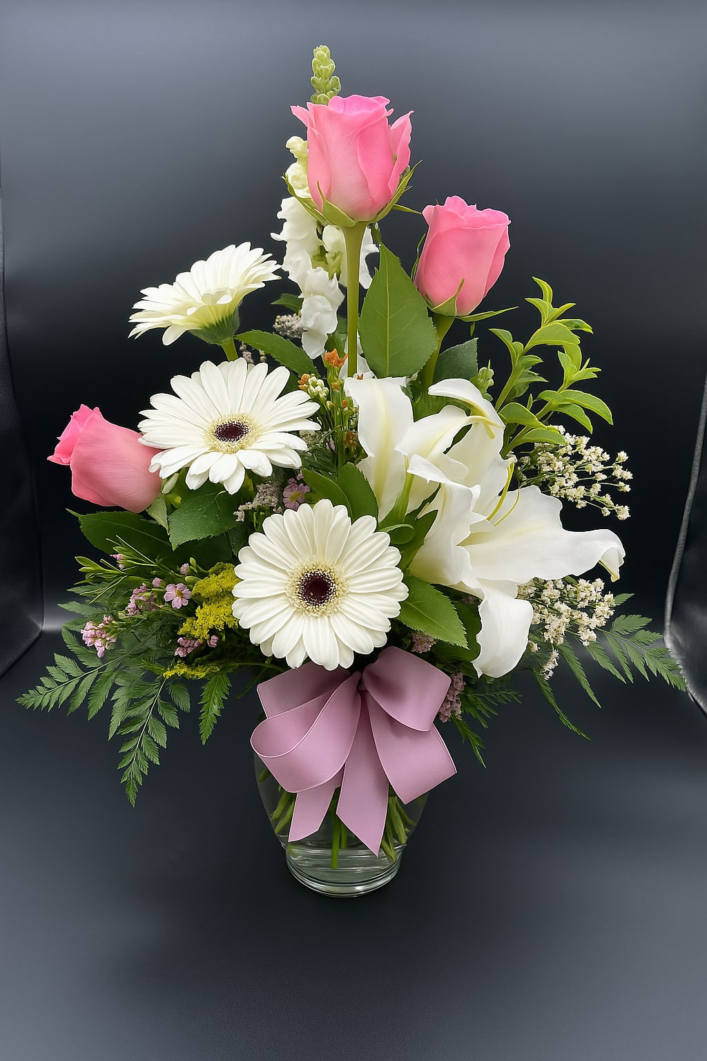 Honoring Life - A radiant tribute filled with love and light. This elegant arrangement speaks from the heart with soft pinks, whites, and fresh greenery—perfect for honoring a beautiful life.