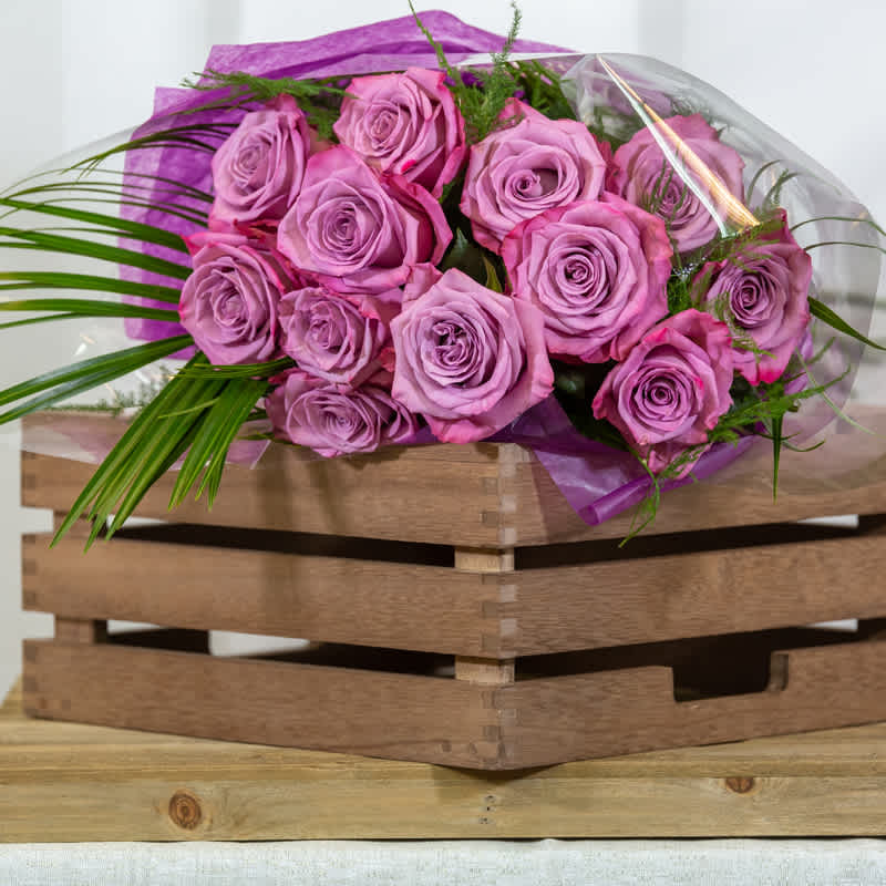 Lavender Rose Wrapped Bouquet - Presentation style bouquet of lavender Roses. This choice does not come with a vase, but the roses will have a water source to ensure freshness.