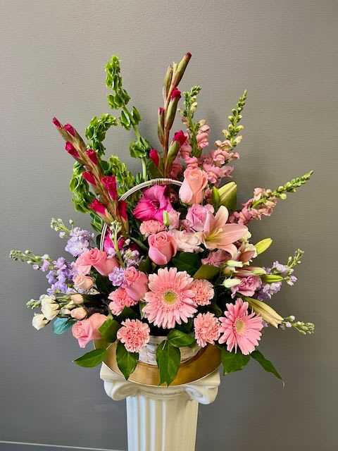 Pink mixed flower arrangement in a gold container