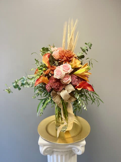 AUTUMN HARVEST - Autumn Harvest is designed in a tall clear glass vase filled with the beautiful colors of Autumn. Pair this with our Pumpkin Spice Voluspa candle for the perfect finishing touch to your gift!  