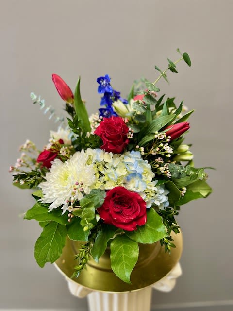 AMERICANA - This red, white, and blue design is arranged in a glass cube and is truly all American!