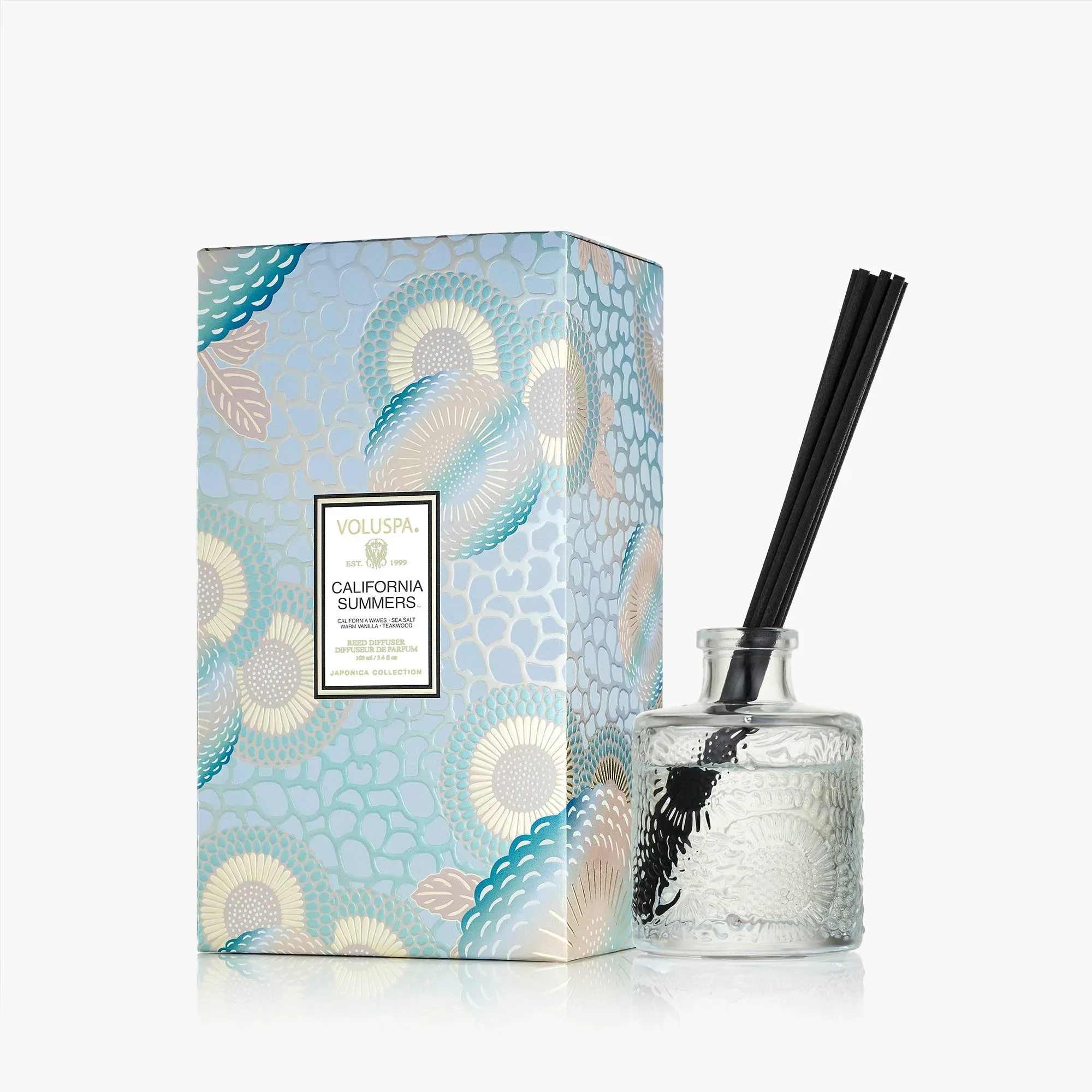 Voluspa California Summers Reed Diffuser - Plunge into the blue horizon and escape into another realm, where worries are reduced to coasting on hypnotic rolling waves. A salty ocean breeze tickles the skin as the sun reaches its peak height of the day, leaving you to bask in a teakwood sling chair, lathered in a tonic of warm vanilla and coconut milk. Welcome in the rising tides to wash away the cares of the day. Voluspa invites you to take the scenic route, so you may always return for California Summers.