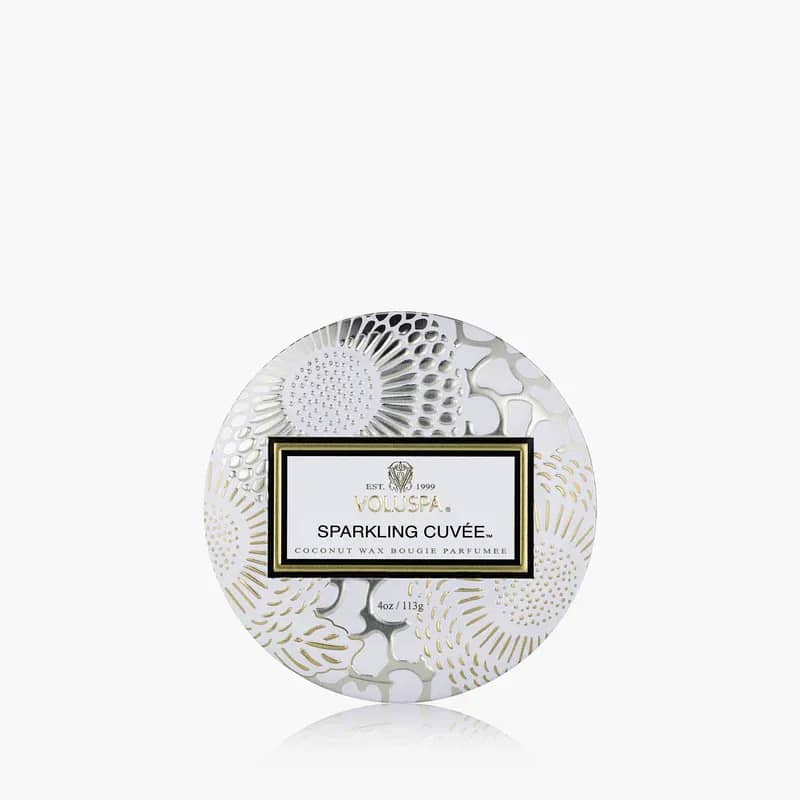 Voluspa Sparkling Cuvée Candles - Pop a bottle of Voluspa’s finest blend, it’s time to celebrate! A mix of beautiful aromatic complexity, Sparkling Cuvée opens with vivacious fruit tones of Sparkling Wine, Pomelo and Red Currant. The effervescence of Sparkling Wine is the heart of the celebration, with bubbles cascading to the surface, dancing and mingling with juicy Nectarine and Bulgarian Rose Petals. A velvety, smooth finish of Woody Oak serves as the perfect stage for this aromatic affair. Raise a glass of Sparkling Cuvée, your olfactory aperitif for every unforgettable occasion.