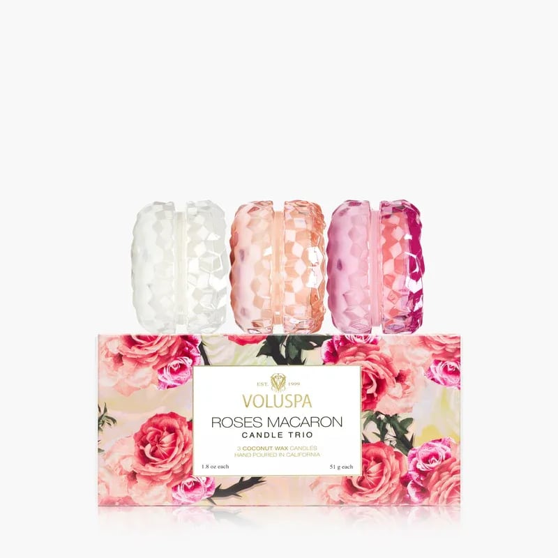 Voluspa Roses Macaron Candle Trio - Step into the garden and lose yourself amidst the enchanting allure of roses. Each rose emanates a unique fragrance, with distinct notes that carry an enchanting fragrance that is both aromatic and dreamlike. Immersed in rich cultural symbolism, the rose stands as an emblem of love, romance, and passion, evoking profound emotional responses when incorporated into fragrances. It’s a tribute to the intricate artistry of fragrance making, where weeks of meticulous cultivation of freshly-picked rose petals are pressed into a single ounce of pure Rose Oil—an elixir of unparalleled value often revered as “liquid gold”. Set includes Milk Rose, Rose Otto, and Rose Petal Ice Cream Macaron Candles packaged in a blooming floral box.
