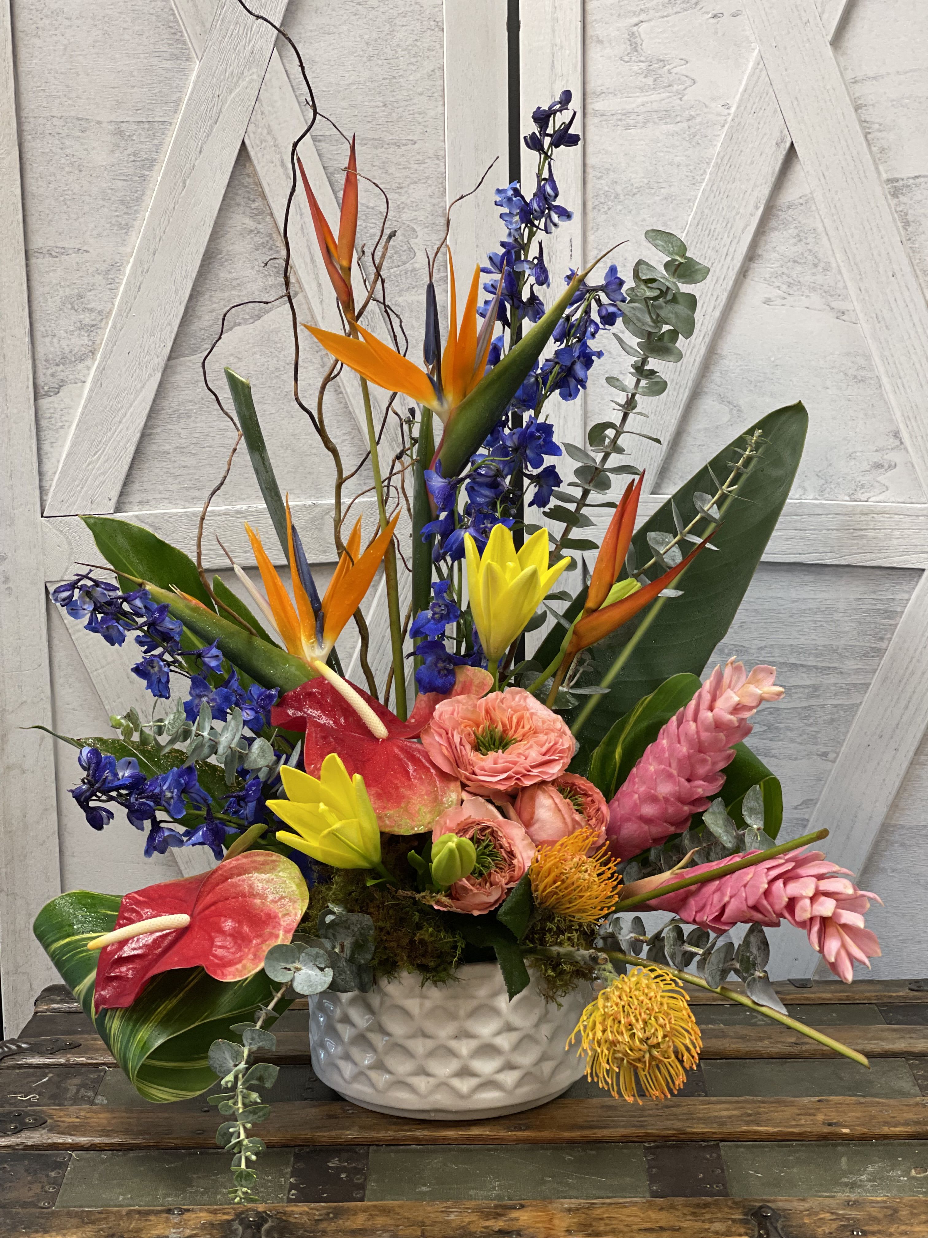 Tropical Tribute - Seasonal Tropical with accenting summer garden flowers in bright colors, container may vary.