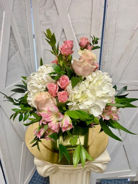 Pink roses and white hydrangeas arranged in a vase