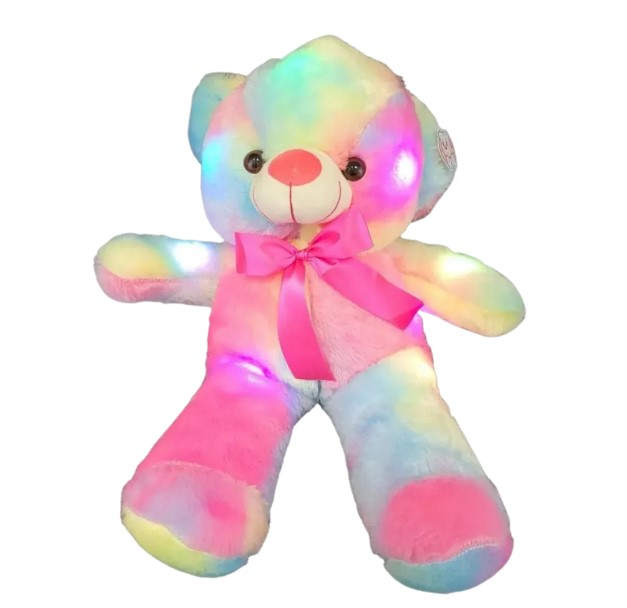 Large rainbow plush teddy bear with glowing lights and pink bow