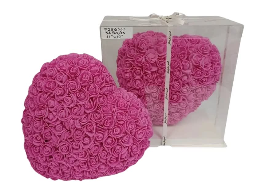 Heart-shaped arrangement of pink artificial roses with one displayed in a clear gift box