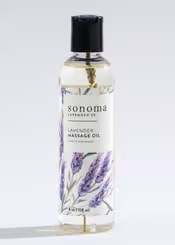 Bottle of lavender massage oil with illustrated purple lavender sprigs and a black cap