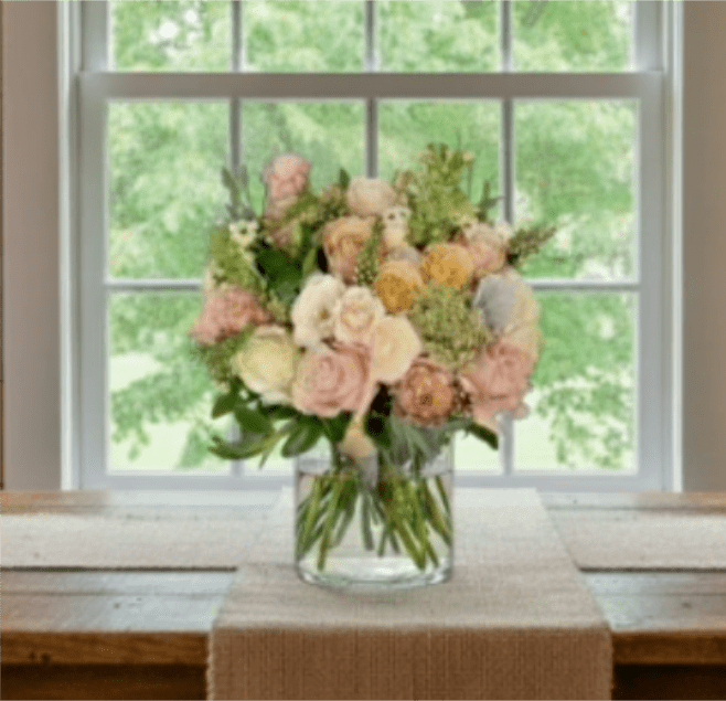 Pastel rose bouquet in a clear glass vase on a table