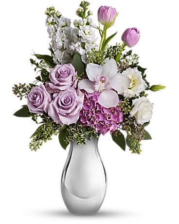 Lavender and white bouquet with roses, tulips, hydrangea, and orchid in a silver vase