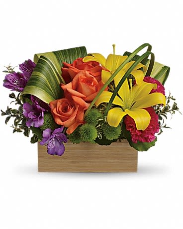 Low wooden box arrangement with yellow lilies, orange roses, purple blooms, and green button mums.