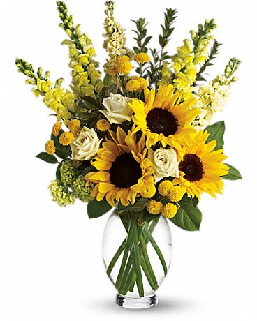 Tall bouquet of yellow sunflowers and white roses in a clear glass vase
