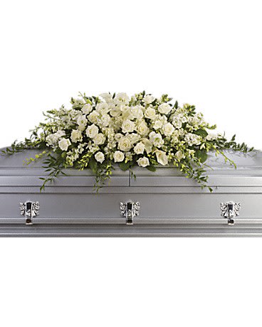Long white rose and calla lily casket spray on a silver coffin