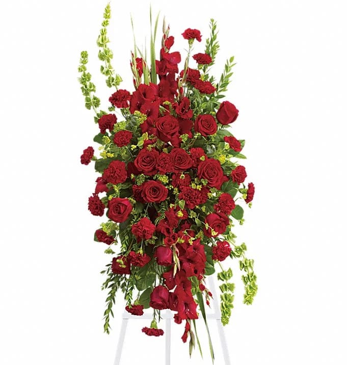 Tall red floral spray on a white stand