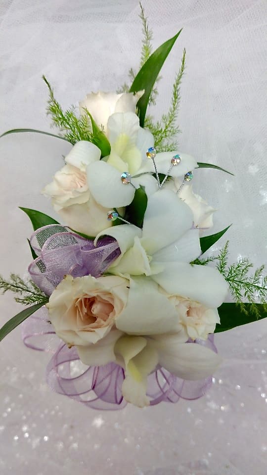 Bouquet of white orchids and pale roses with purple ribbon