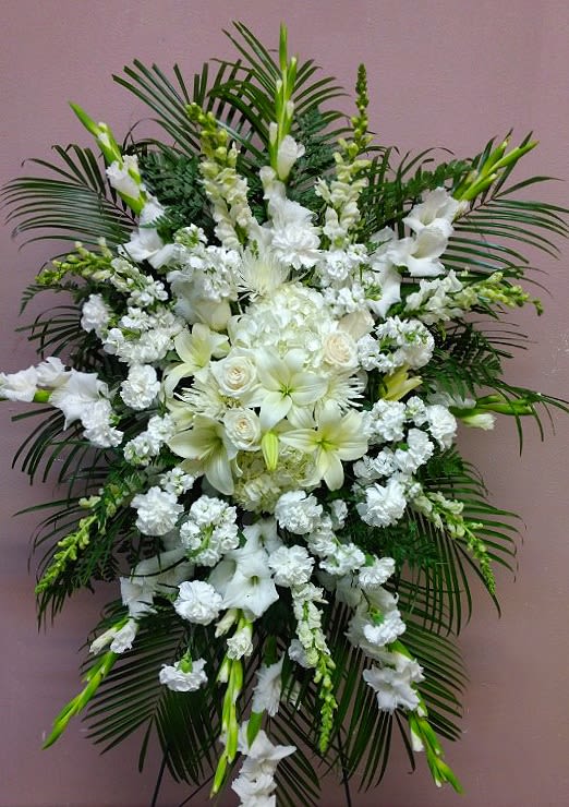 Large white funeral spray with lilies and roses