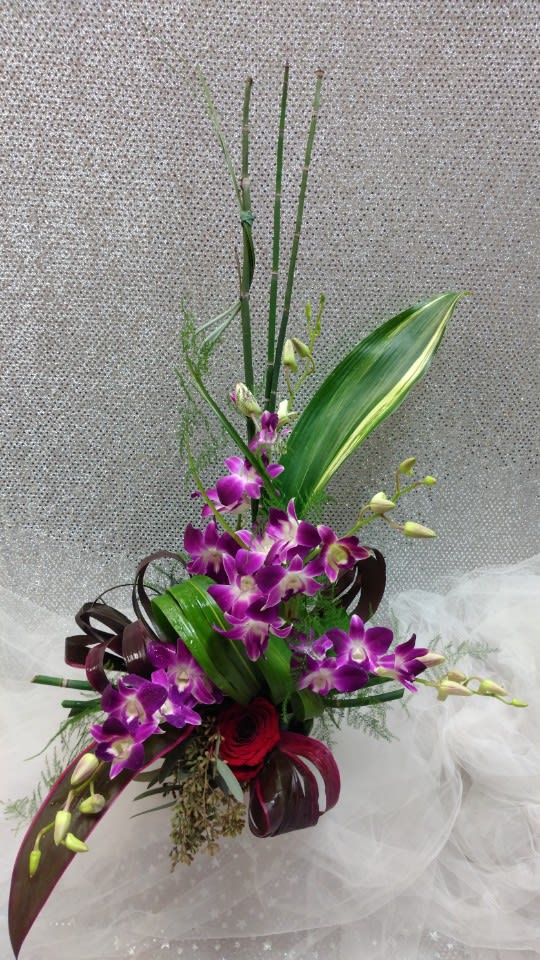 Tall bouquet with purple orchids and red roses