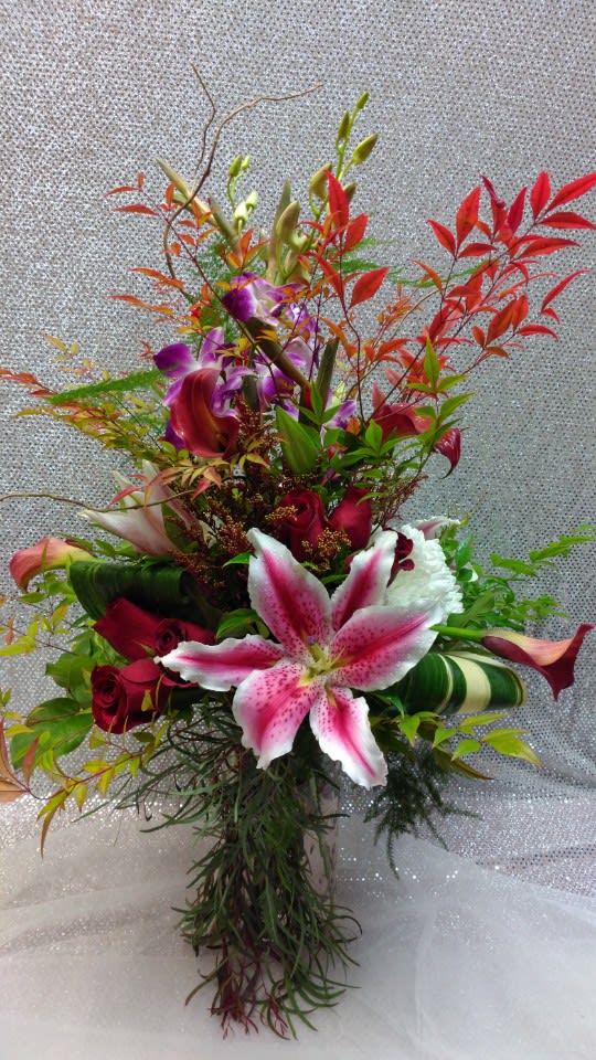 Tall bouquet of pink lilies, red roses, and purple orchids