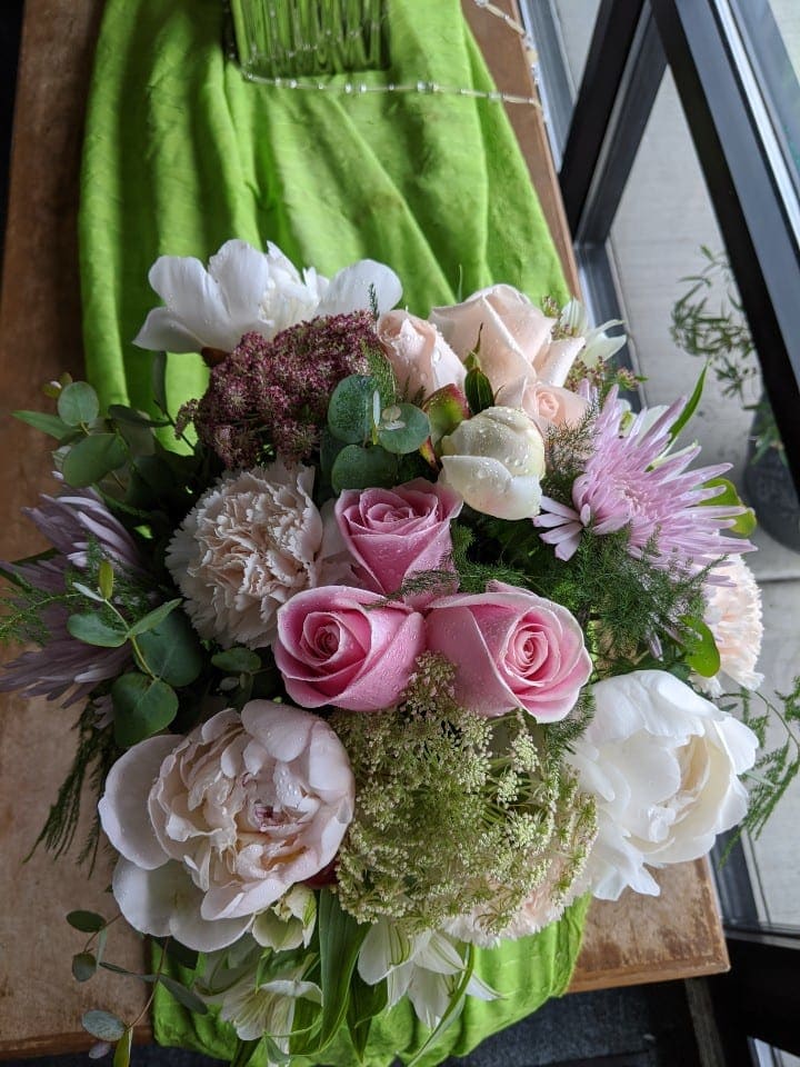 Bouquet of pink and white roses with mixed blooms and greenery