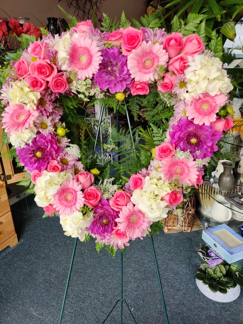 Heart-shaped floral wreath with pink roses, gerbera daisies, and white blooms