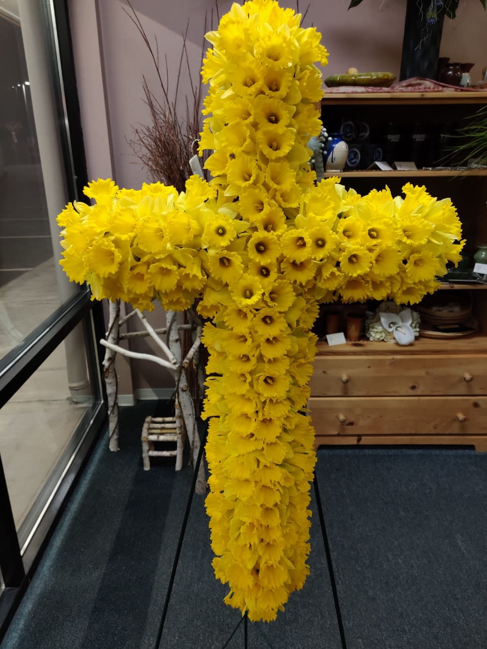 Large yellow floral cross made of daffodils