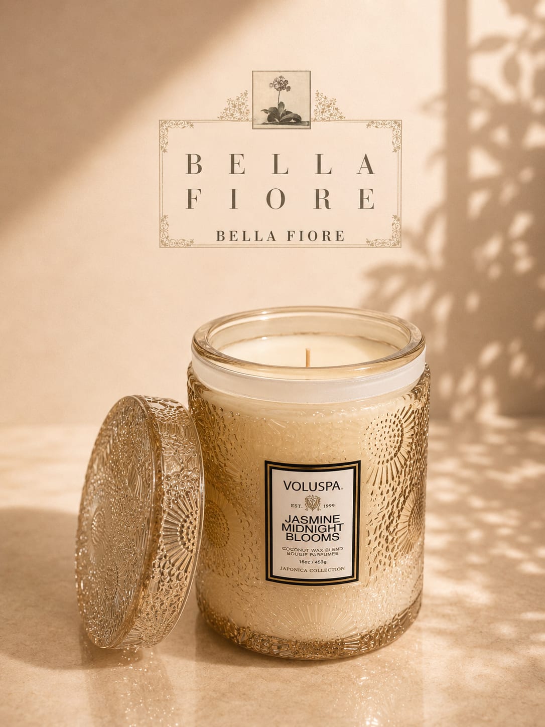 Decorative jasmine-scented candle in a glass jar with a patterned lid
