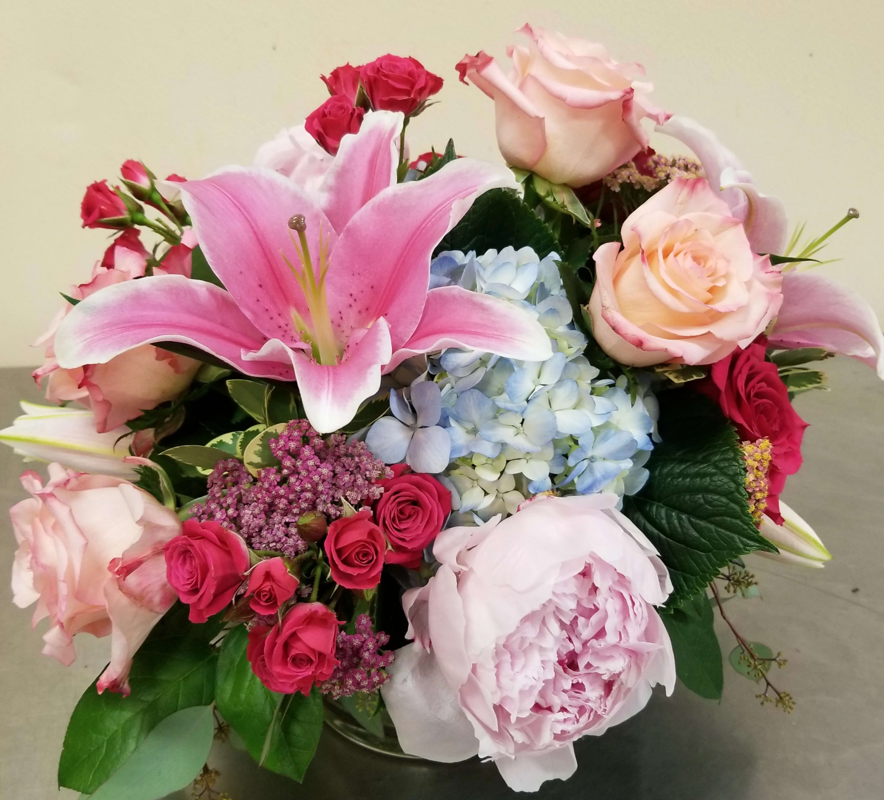 "Opulence" Bouquet - Mixed premium flowers, all arranged in our signature style! We use the most spectacular specimens from our daily flower shipments to deliver a stunning array of beauty! Flowers may include Oriental lilies, roses, hydrangea, and other high end blossoms. Call for daily selections available, or leave it up to our talented designers to use the best!