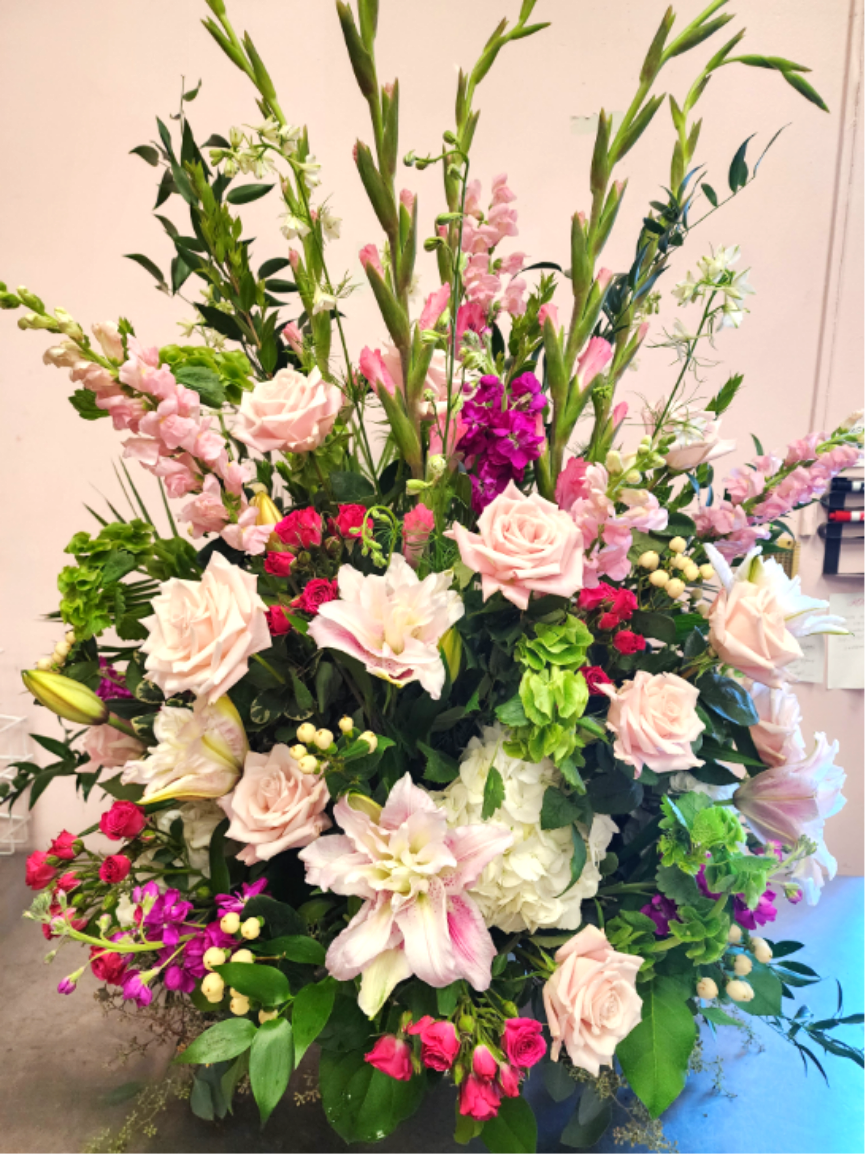 Large mixed flower arrangement with pink roses and lilies
