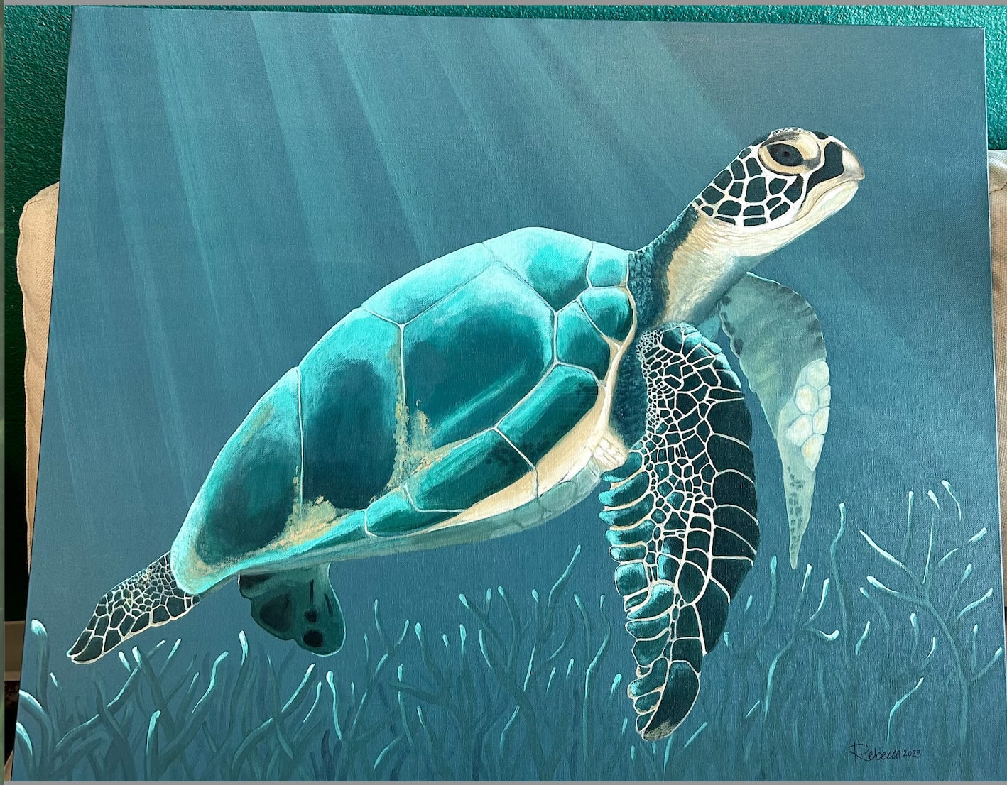 Painting of a sea turtle swimming in blue water