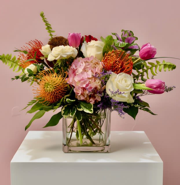 Petal Pop Fireworks - A vibrant arrangement featuring striking pincushions surrounded by soft pink and white blooms. Bold, playful, and full of movement — like a burst of petals lighting up the sky in celebration. 