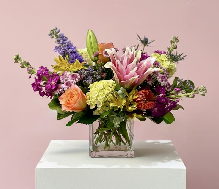 Floral Canvas  - A vibrant floral masterpiece featuring a colorful blend of premium seasonal blooms. Designed with rich textures and an artistic balance of color, Floral Canvas is a cheerful, garden-inspired arrangement that brings beauty, creativity, and elegance to any occasion.