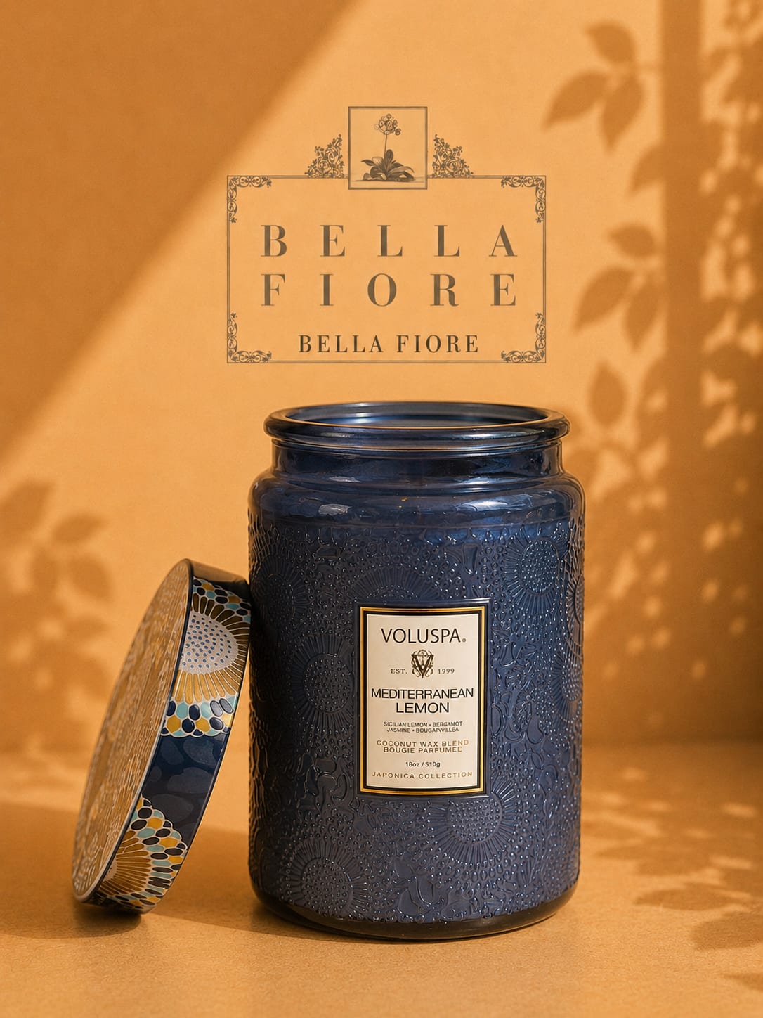 Blue scented candle in a decorative glass jar with lid