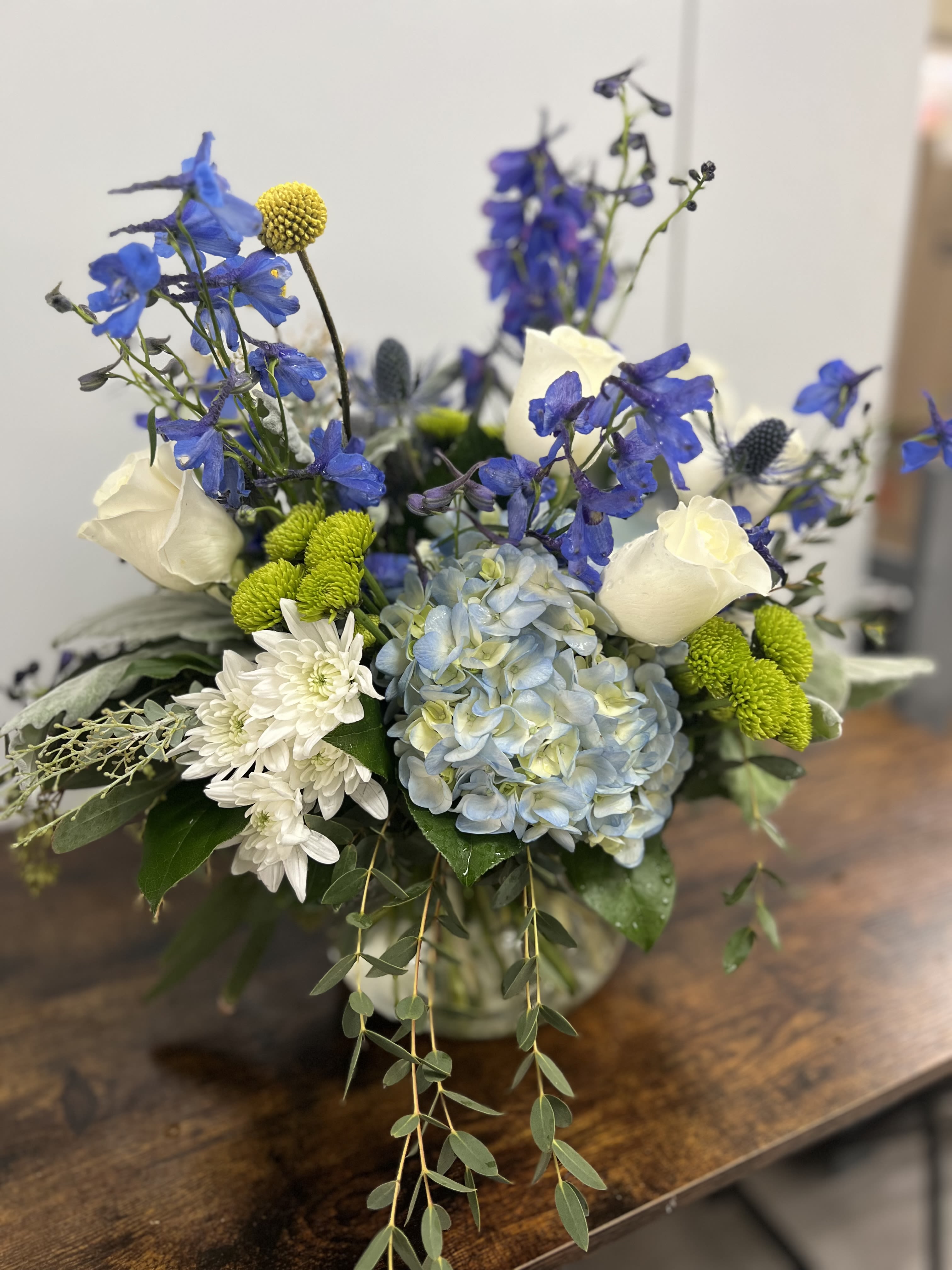 Blue and white floral arrangement in a glass vase