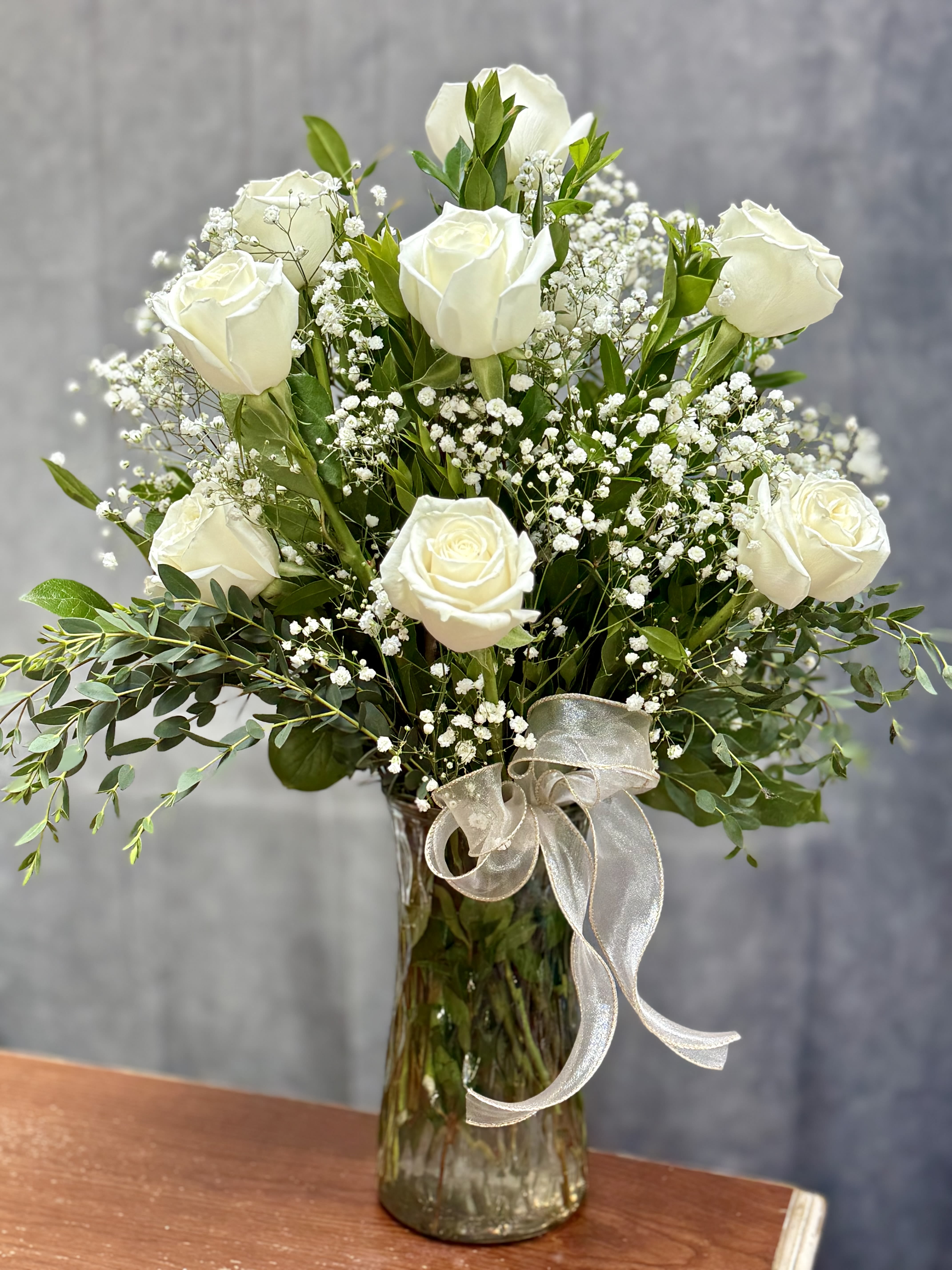 White Roses Vase  - Classic White Roses  A Timeless arrangement of white roses, accented with baby’s breath and greenery in a glass vase. 