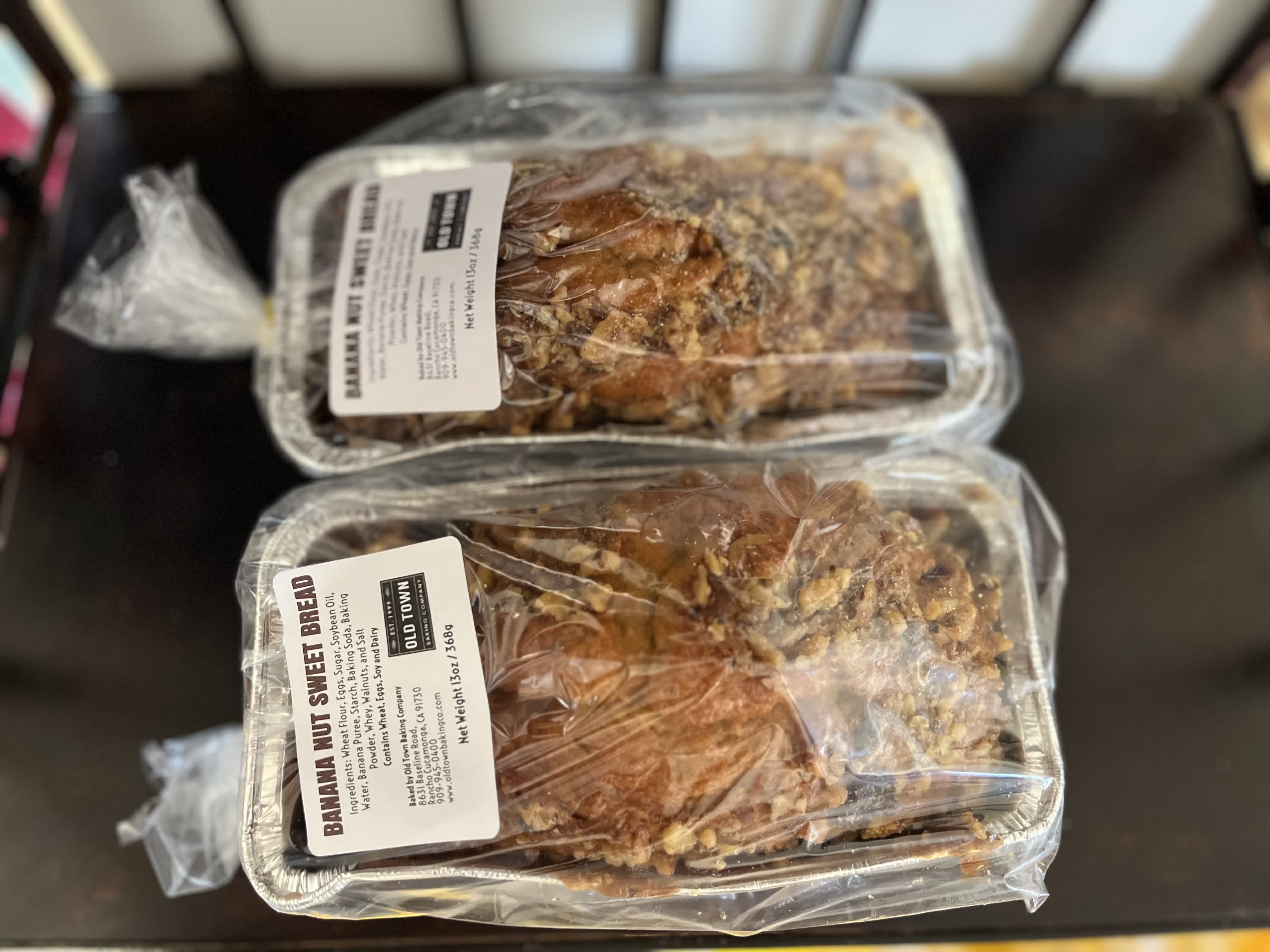 Two packaged loaves of banana nut sweet bread on a table