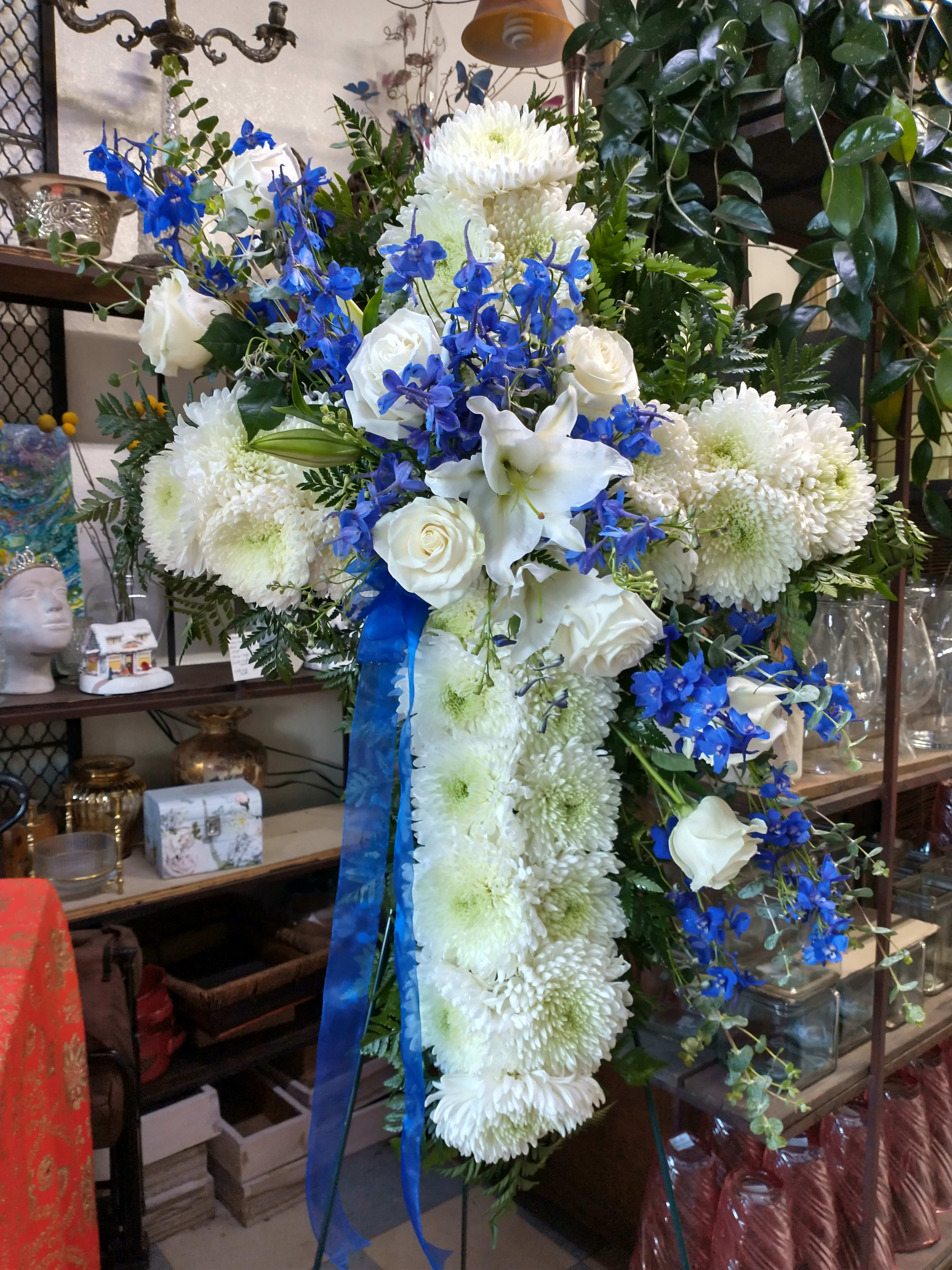 Blue and white cross - Lovely display with roses lilies blue delphinium. 