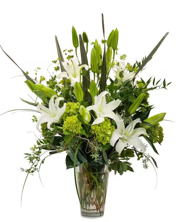 NATURALLY ELEGANT - A elegant combination of premium foliage, green hydrangea and hybrid lilies in a clear vase.  
