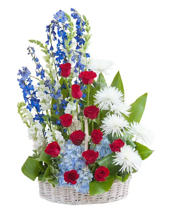 HONOR BASKET TRIBUTE - A basket filled with an honorable display of red, white, and blue flowers.  