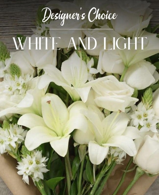 White lilies and small white flowers in a bouquet