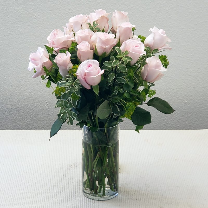 Light Pink Rose Bouquet  - Light Pink Rose Bouquet can be sent as the perfect gift for the Princess in your life.   Fuller, fabulous, and long-lasting, this arrangement brings elegance and charm to any occasion. Roses delivery comes in a clear glass vase.  Approximately 18" H x 16" W. The Standard bouquet includes 12 stems. The Deluxe bouquet includes 18 stems. The Deluxe bouquet includes 24 stems.