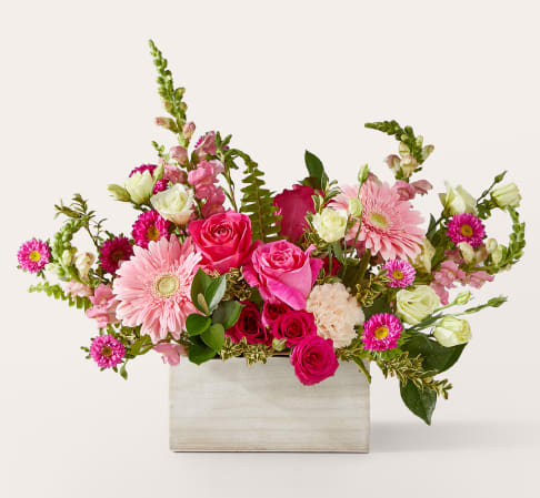 Pink and white mixed flower arrangement in a rectangular wooden box