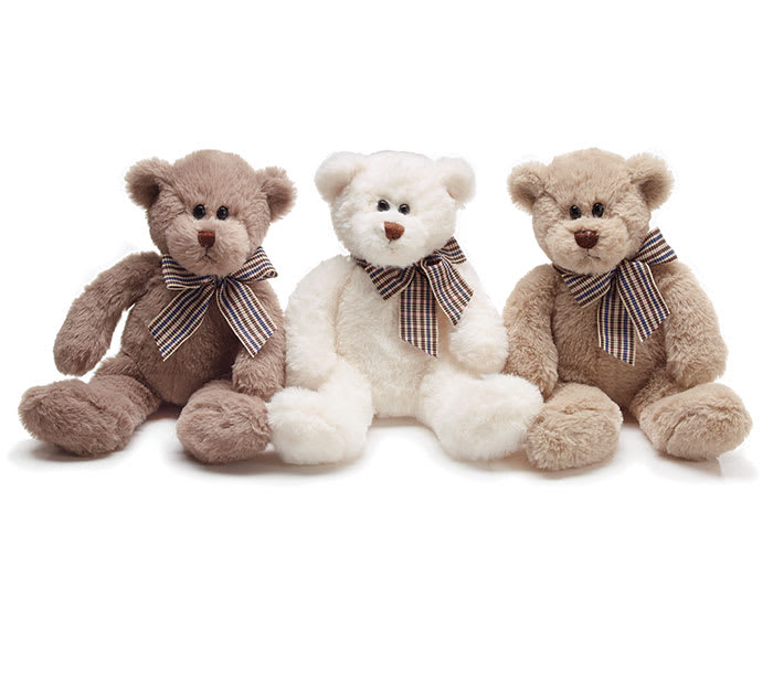 Three teddy bears with plaid bows sitting side by side