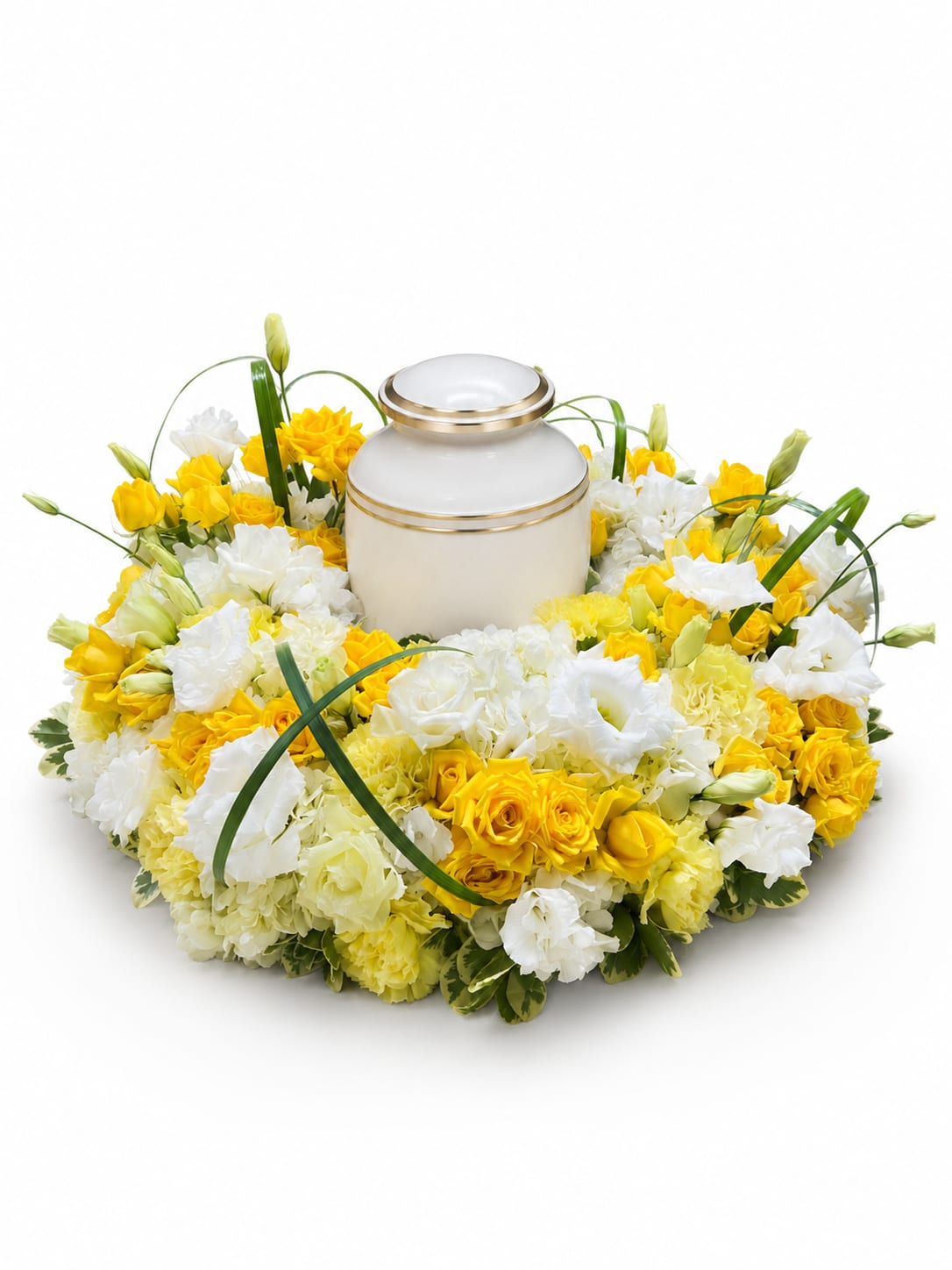 Golden Rays Urn Wreath - Honor a cherished life with the Golden Rays Urn Wreath, a radiant floral tribute designed to surround an urn with warmth, love, and remembrance. This elegant arrangement features a harmonious blend of vibrant yellow roses, soft white carnations, delicate lisianthus, and seasonal blooms, accented with graceful greenery. The circular design symbolizes eternity, making it a meaningful centerpiece for funeral, memorial, or celebration of life services.  The bright yellow flowers represent friendship, hope, and treasured memories, while the crisp white blooms convey peace, purity, and everlasting love. Whether displayed during a funeral service or memorial gathering, the Golden Rays Urn Wreath offers a comforting expression of sympathy and a beautiful tribute to a life well lived.  Each urn wreath is handcrafted by our experienced florists using fresh, premium flowers and may vary slightly based on seasonal availability while maintaining its overall style and color palette.
